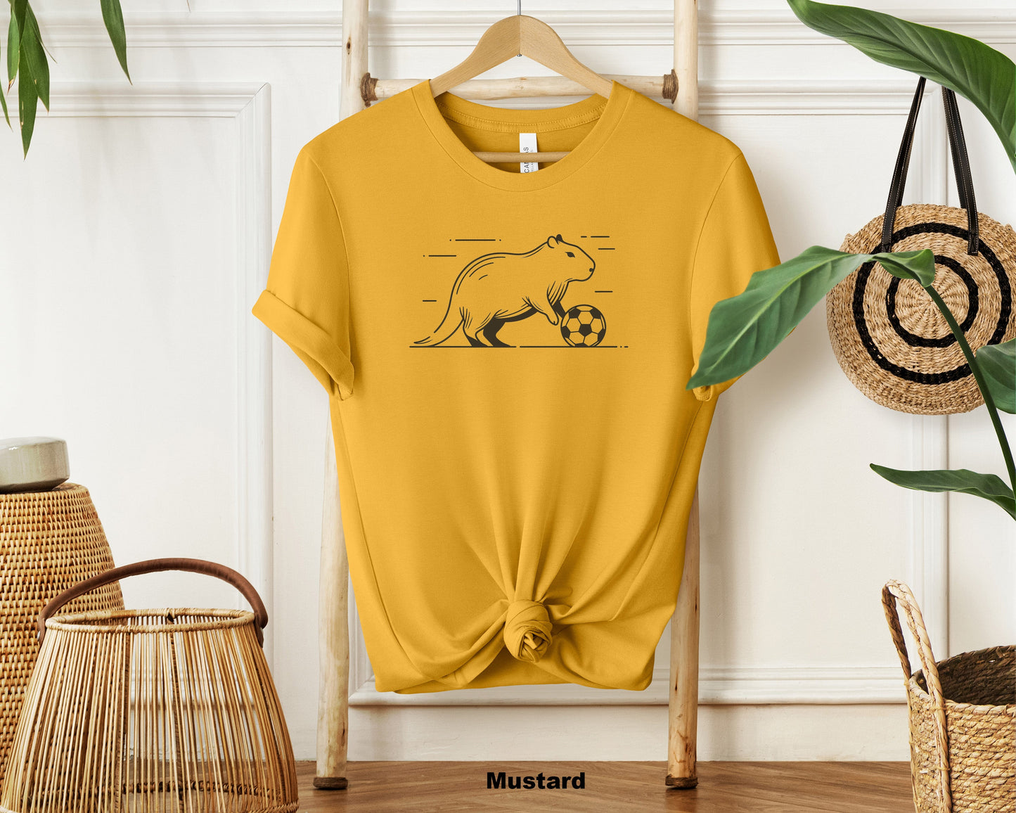 "Cute Capybara Playing Football Unisex Cotton T-shirt - Funny Animal Sports Tee for Football Lovers"